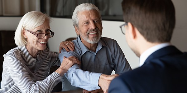 Pleased senior couple meeting with advisor