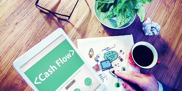 Person holding tablet and graph to depict cash flow