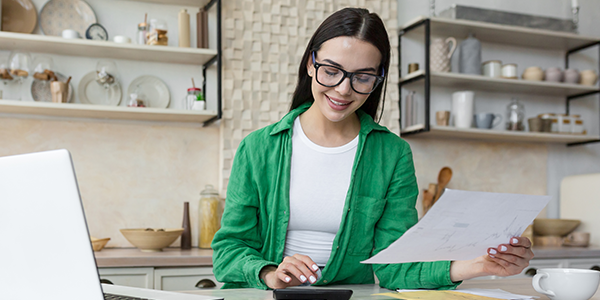 Woman with look of excitement while reviewing finances