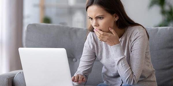 Woman researching more about checks on laptop